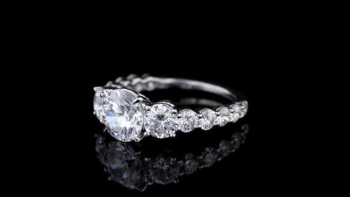 Three Stone Engagement Ring Featuring Round Diamonds In A Shared Prong Setting