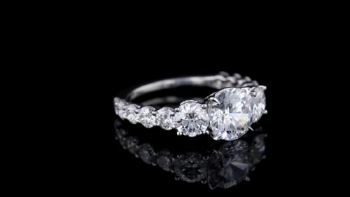 Three Stone Engagement Ring Featuring Round Diamonds In A Shared Prong Setting