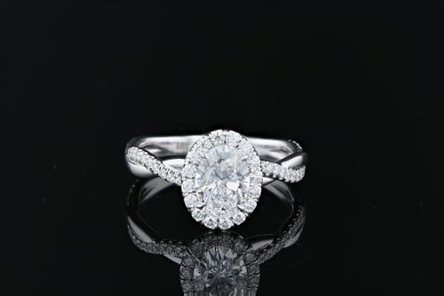 Oval shaped diamond halo engagement ring with a braided pave set diamond band
