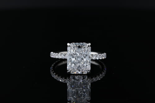 Radiant cut diamond solitaire with pave set diamond hidden halo