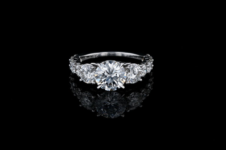 Three Stone Engagement Ring Featuring Round Diamonds In A Shared Prong Setting