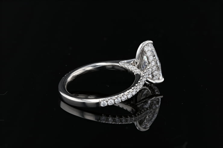 Pear shape diamond set in pave setting with a diamond pave hidden halo