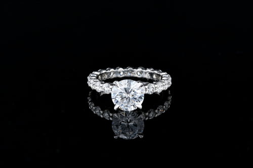 Side Stone Round Solitaire Shared Prong Band