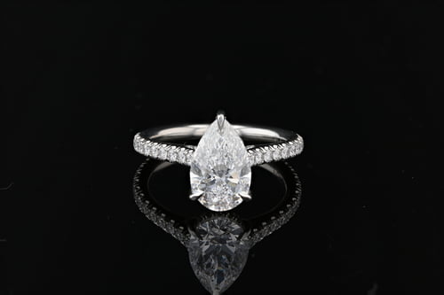 Pear shape diamond set in pave setting with a diamond pave hidden halo