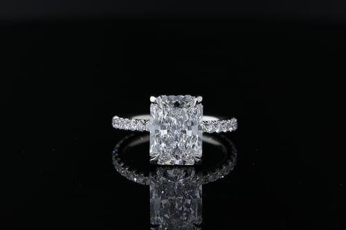 Side Stone Three sided pave set Radiant cut diamond solitaire with pave set diamond hidden halo